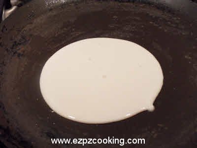 Drop a spoonful of dosa batter on the griddle