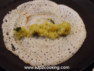 Top the dosa with the filling