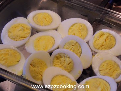 Cut eggs in half and place in a serving dish