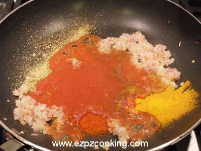 Add spices and tomato puree