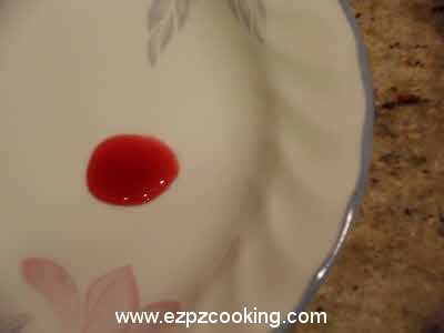 Running drop of plum jam