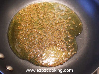 Crackle the cumin seeds for dhuli masoor dal tempering