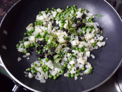 Add curry leaves, green peas and raisins