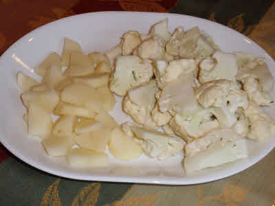 Cut phool gobhi and potatoes