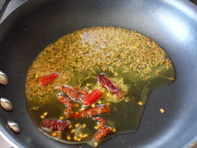 Add asafoetida and whole red chillies