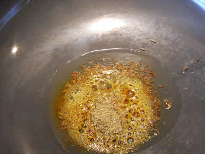 Add turmeric powder, chili powder, coriander powder