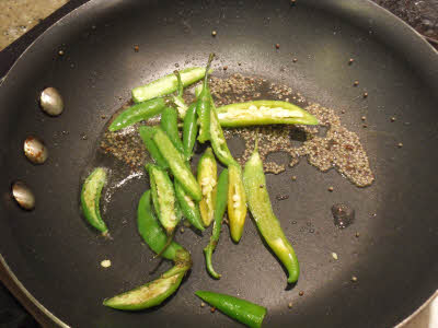 Add slit green chillies to the Dhokla tempering
