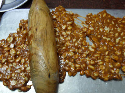 Flatten the chikki mixture using the rolling pin