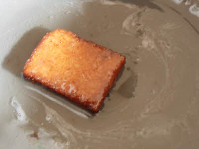 dip a bread pieces in the sugar syrup