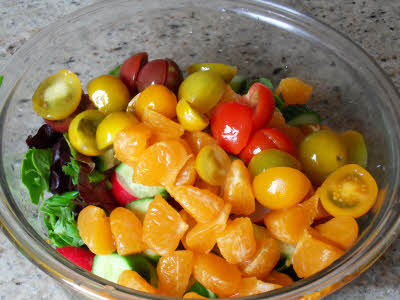 Cut tomatoes and lettuce for mandarin salad