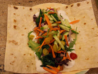 Top the wrap with fresh vegetables