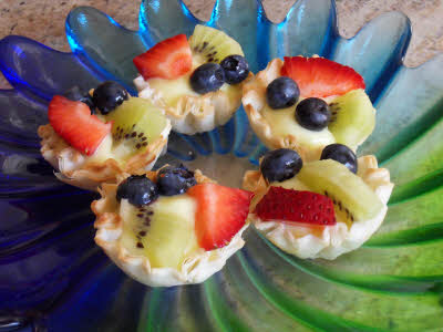 top the fruit tart with fruits
