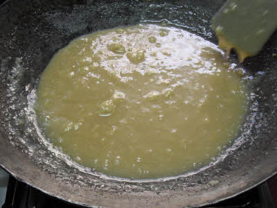 Add sugar syrup to til ki burfi batter