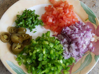 Chop vegetables for tortilla pizza