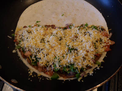 Spread vegetables on tortilla for quesadilla