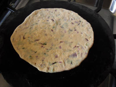 Place paneer parantha on the griddle