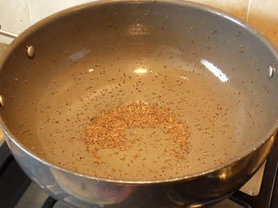 Pop mustard seeds for tomato rice