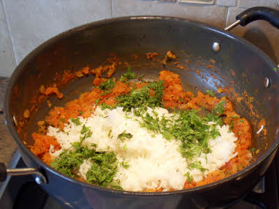 Add salt, boiled rice and chopped coriander leaves