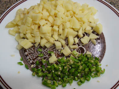 Chop potatoes and green chillies