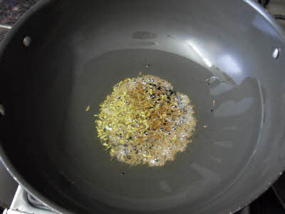 Oil + cumin + onion seeds + fennel