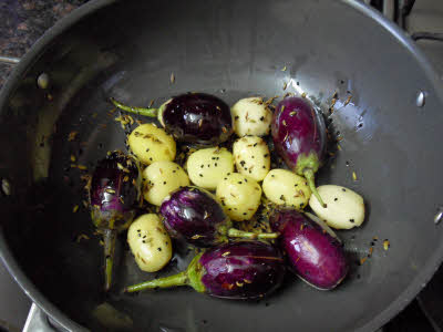 Add slit eggplants and potatoes