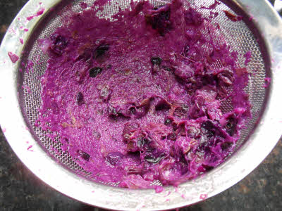 Pressing jamun through the sieve