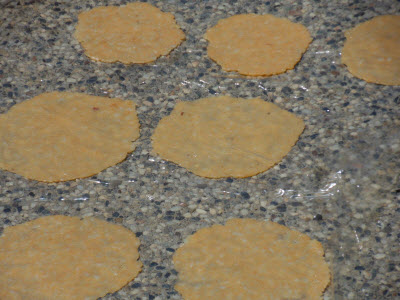 Stick aloo papad on a plastic sheet to dry in sun
