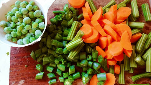 Slice onion, carrots, beans and drumsticks coarsely