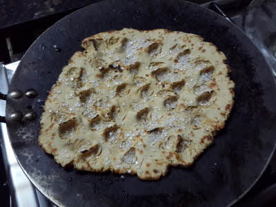 Add sugar and seeds on roti