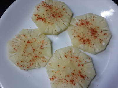 sprinkle with salt and chilli powder on pineapple roundels