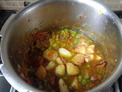 Cook potatoes and peas