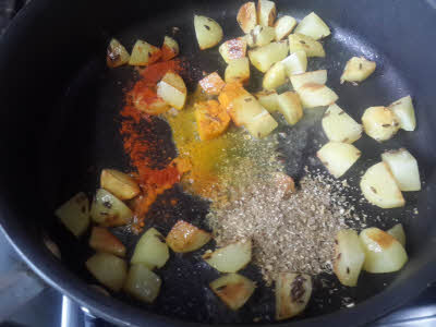 Add cumin powder, turmeric powder, chillies powder, coriander powder