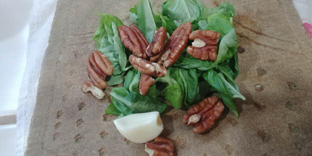 Grind basil leaves, nuts and garlic clove