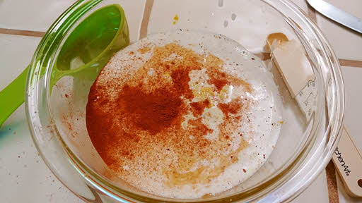 whisk together the egg yolks, sugar, half and half, rum, vanilla, nutmeg, cinnamon and zest