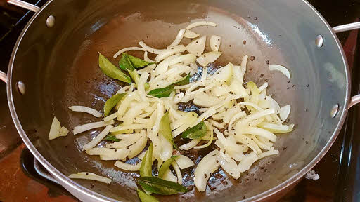 Add sliced onion and kari leaves