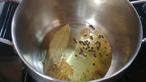 heat clarified butter and add cumin seeds, black pepper, cloves and bay leaf
