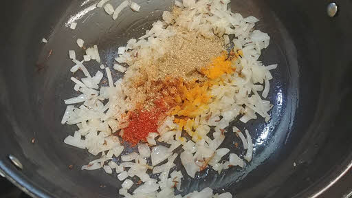 Add turmeric powder, chili powder, coriander powder