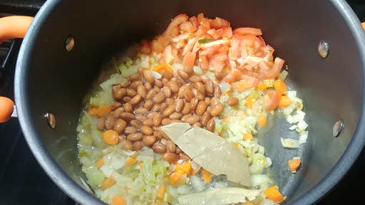Add stock, tomatoes and beans