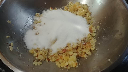 Add chopped nuts, cardamom powder and sugar