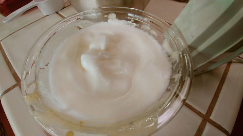 Whisk egg whites in a separate bowl