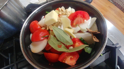Boil onion, tomatoes and cashews