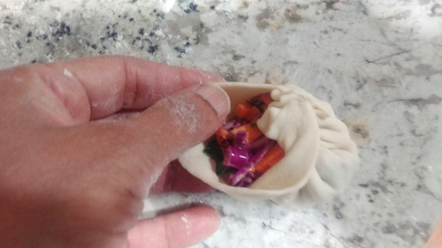 Fold the momos