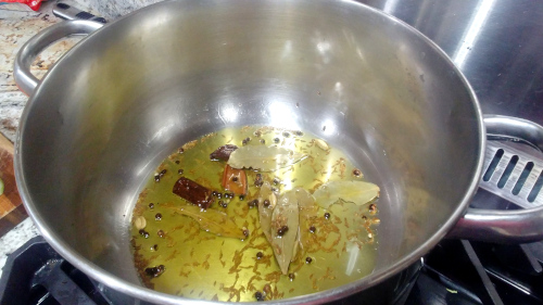 Heat the ghee in a saucepan and add cumin seeds, cinnamon stick, black pepper, and cardamom